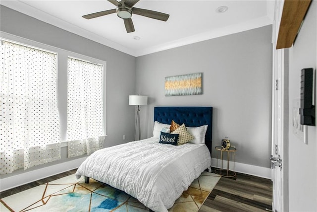 bedroom with ornamental molding, dark hardwood / wood-style flooring, and ceiling fan