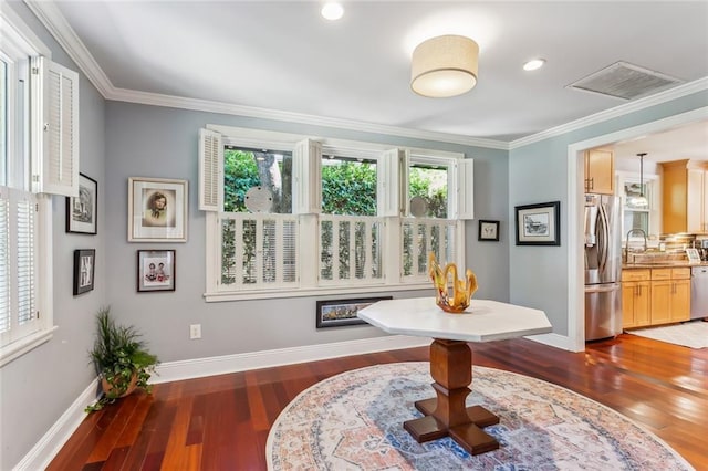 interior space featuring plenty of natural light, dark wood-type flooring, and crown molding