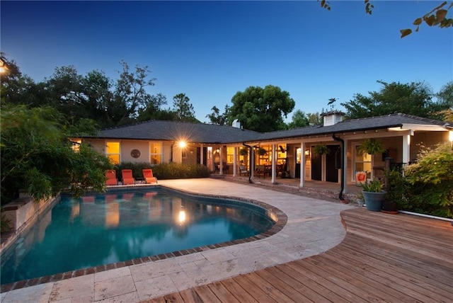 pool at dusk with a patio