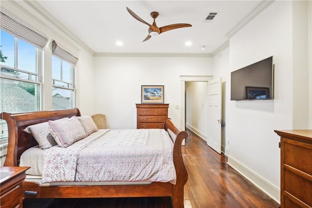 bedroom with crown molding, ceiling fan, and dark hardwood / wood-style flooring