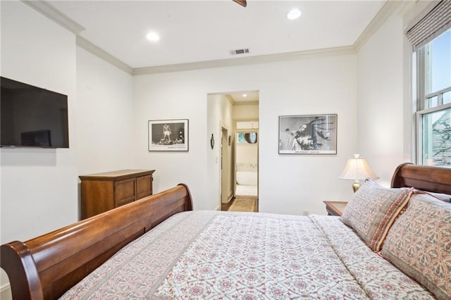 bedroom with ensuite bathroom and crown molding