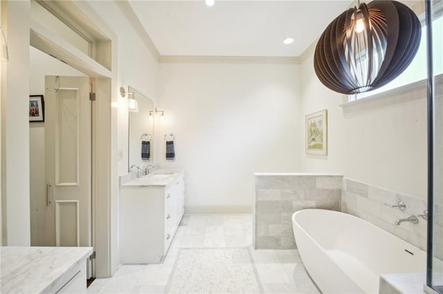 bathroom with vanity, tile patterned floors, crown molding, and a tub