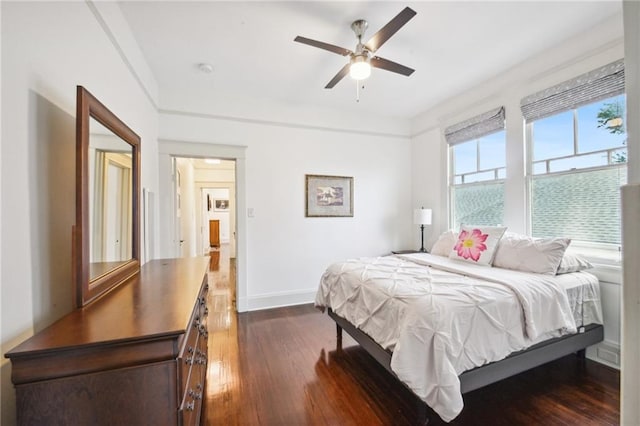 bedroom with ceiling fan and dark hardwood / wood-style flooring