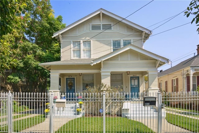 view of front of property with covered porch and a front yard