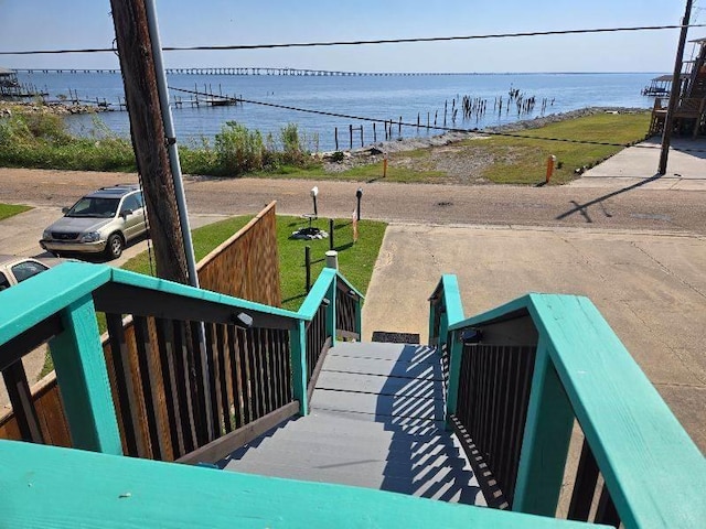 wooden terrace featuring a water view