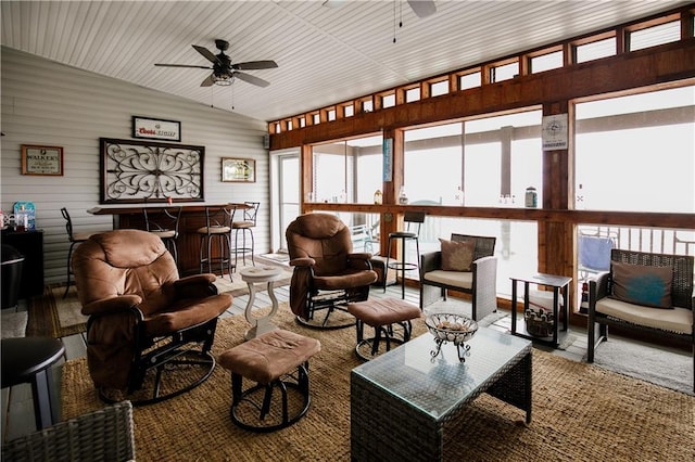 interior space with ceiling fan, indoor bar, and vaulted ceiling