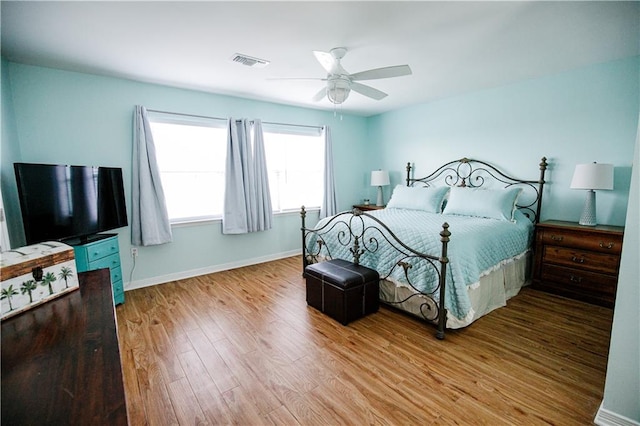 bedroom with light hardwood / wood-style flooring and ceiling fan