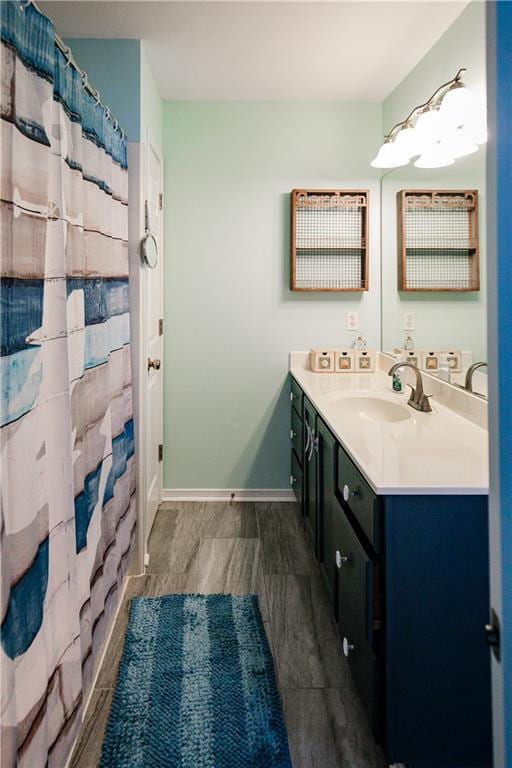 bathroom featuring vanity and curtained shower