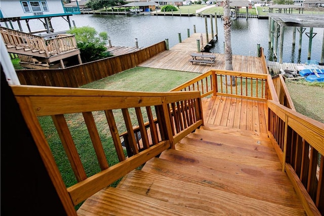 wooden deck featuring a boat dock and a water view