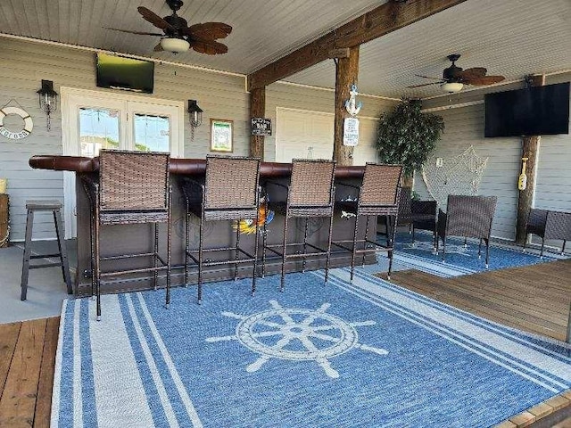 view of patio featuring an outdoor bar and ceiling fan