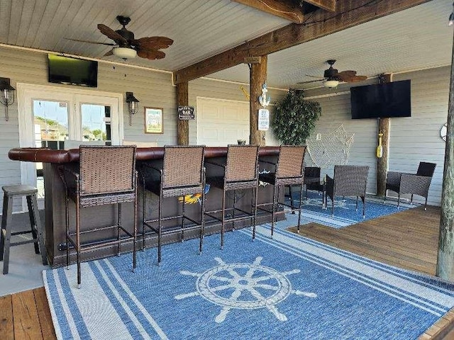 view of patio / terrace with an outdoor bar and ceiling fan