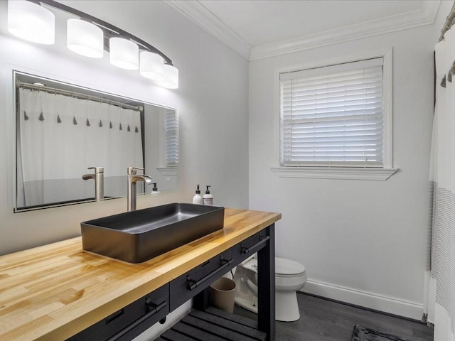 bathroom featuring a shower with shower curtain, vanity, crown molding, hardwood / wood-style floors, and toilet