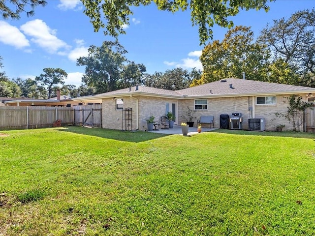 back of property featuring cooling unit, a patio area, and a lawn