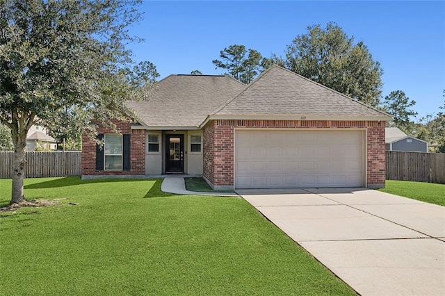 view of front of home featuring a front yard and a garage