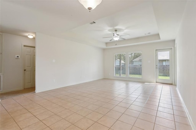 tiled spare room with ceiling fan