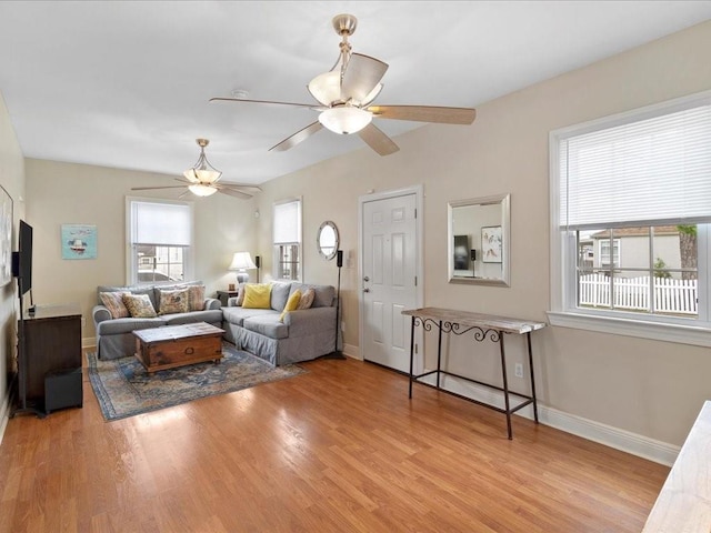 living room featuring ceiling fan and light hardwood / wood-style flooring