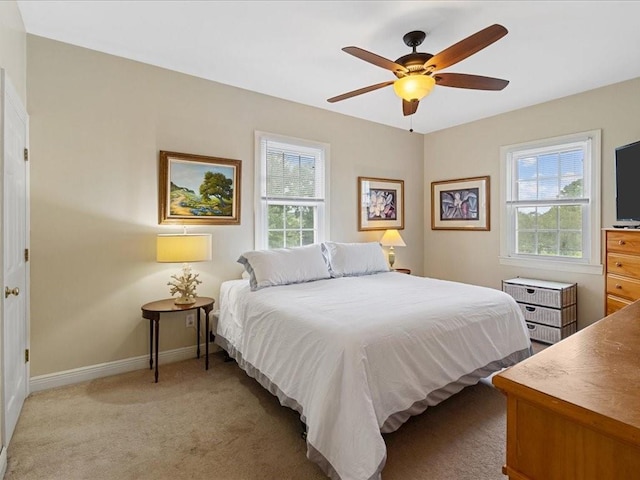 bedroom with light carpet and ceiling fan