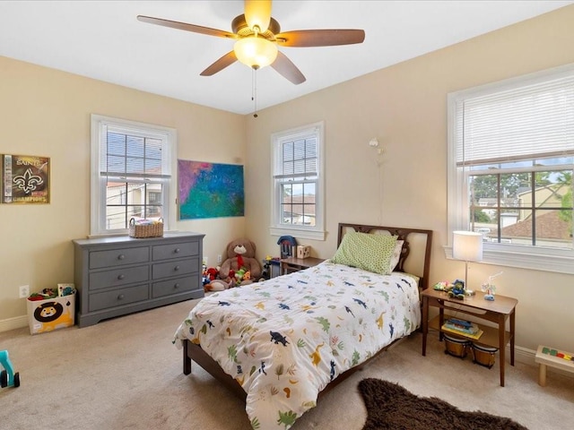 bedroom featuring light colored carpet and ceiling fan