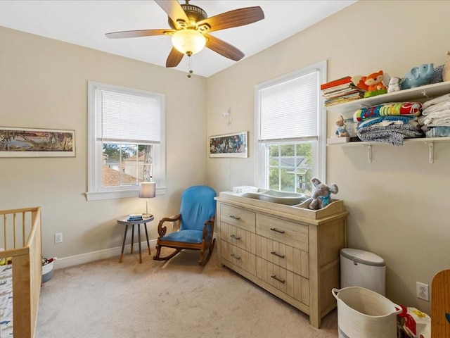 bedroom featuring multiple windows, ceiling fan, and light colored carpet