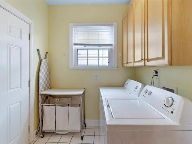 laundry area featuring independent washer and dryer, cabinets, and light tile patterned floors