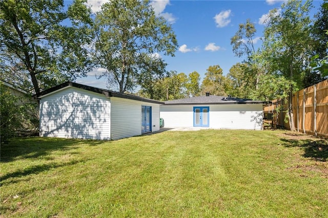 rear view of property featuring a yard