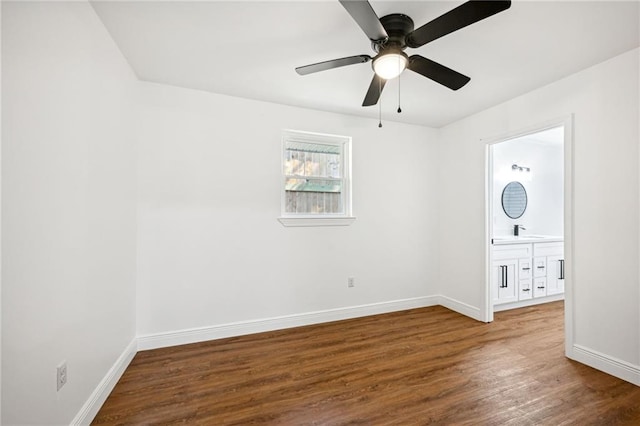 spare room featuring dark hardwood / wood-style floors, sink, and ceiling fan