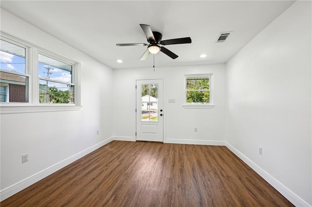 spare room featuring ceiling fan and dark hardwood / wood-style floors