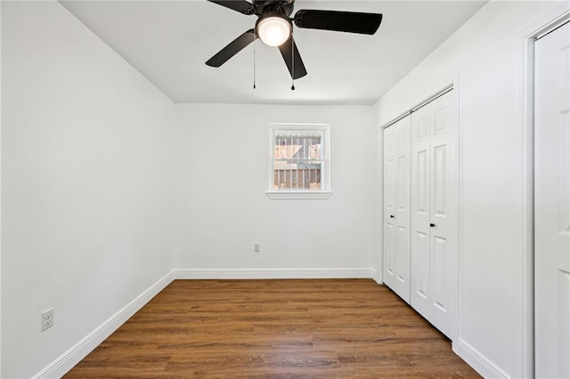 unfurnished bedroom featuring hardwood / wood-style floors, ceiling fan, and a closet