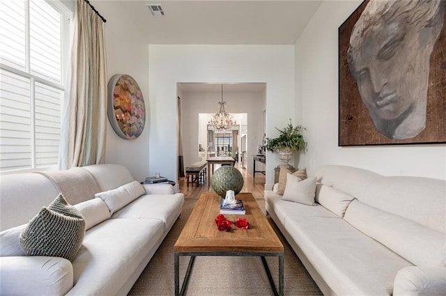 living room featuring wood-type flooring and a chandelier