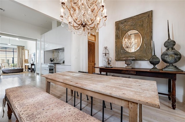 dining area with an inviting chandelier and light wood-type flooring