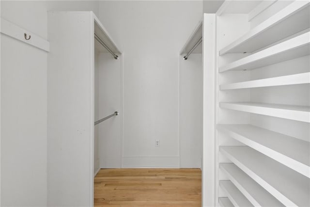 walk in closet featuring light hardwood / wood-style floors