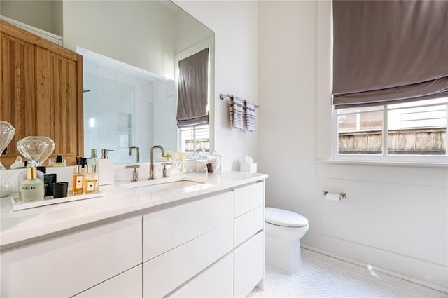 bathroom featuring vanity, a shower, and toilet