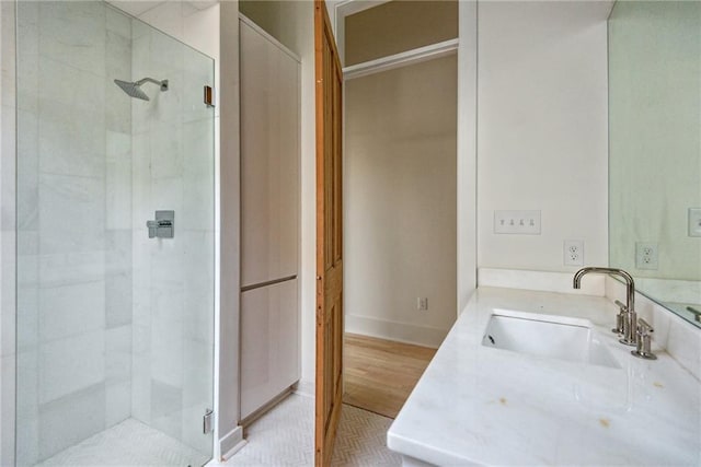 bathroom featuring hardwood / wood-style floors, vanity, and a shower with shower door