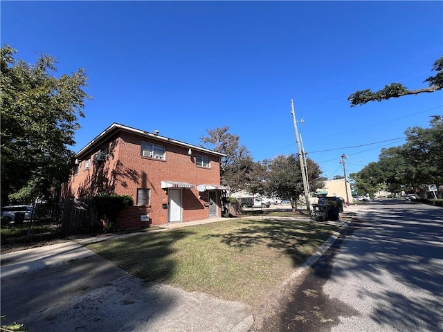 view of side of home featuring a yard