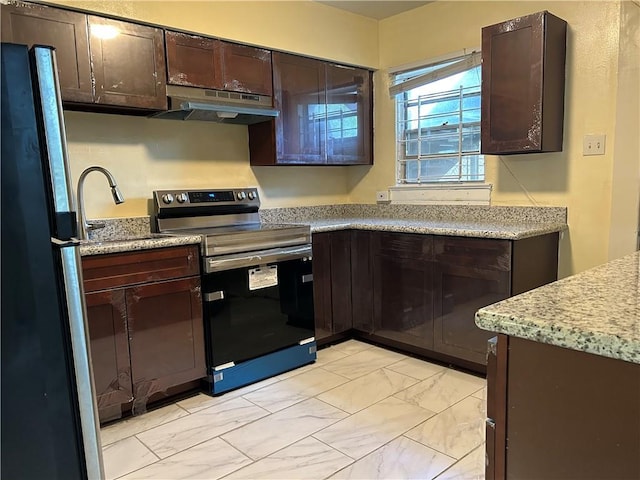 kitchen featuring dark brown cabinetry, fridge, stainless steel range with electric stovetop, and sink