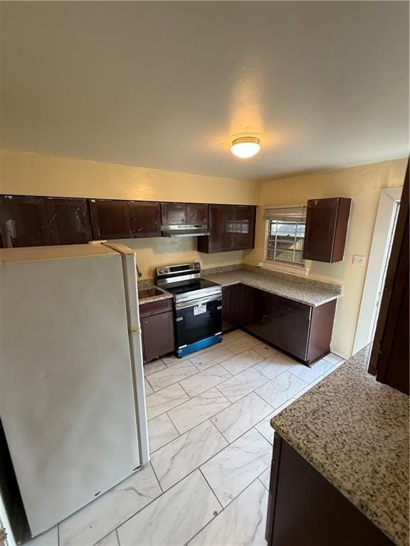 kitchen with white refrigerator, light stone counters, dark brown cabinetry, and stainless steel electric range