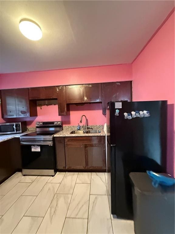 kitchen featuring ventilation hood, sink, dark brown cabinets, and appliances with stainless steel finishes