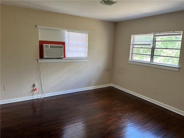 spare room featuring dark hardwood / wood-style floors and cooling unit