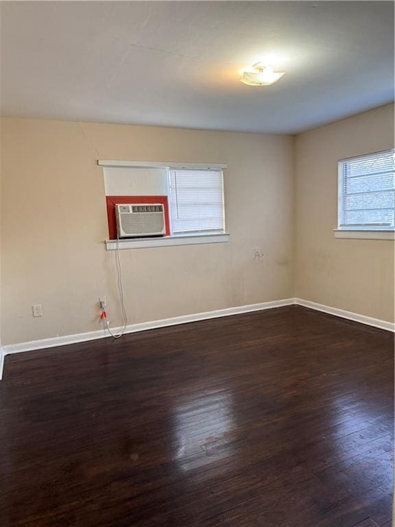 unfurnished room featuring dark hardwood / wood-style floors and cooling unit