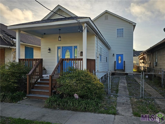 3019 Eagle St, New Orleans, LA 70118 - shotgun-style home with covered porch and a gate