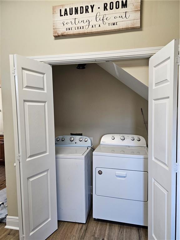 3019 Eagle St, New Orleans, LA 70118 - laundry area with dark wood-style floors and washer and dryer