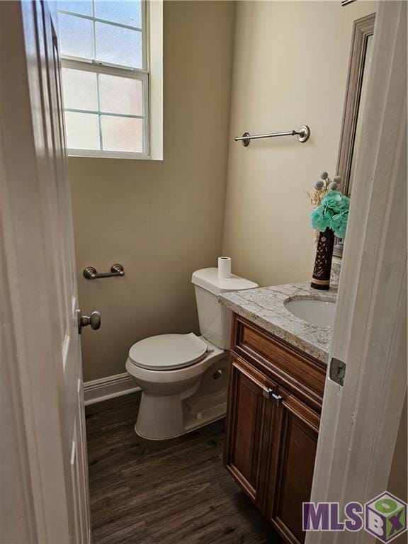 3019 Eagle St, New Orleans, LA 70118 - half bath featuring vanity, toilet, wood finished floors, and baseboards