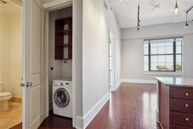 washroom with dark hardwood / wood-style floors and washer / clothes dryer