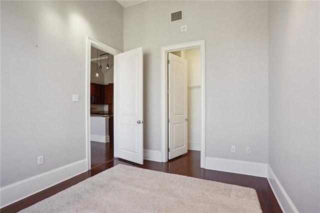 unfurnished bedroom featuring dark hardwood / wood-style floors