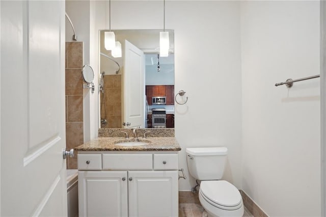 bathroom featuring vanity, walk in shower, and toilet