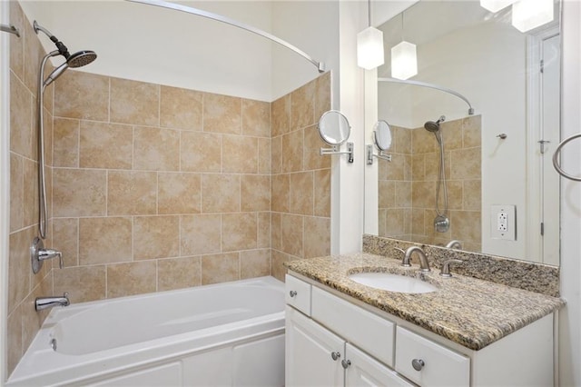 bathroom featuring vanity and tiled shower / bath combo