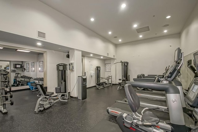 gym with a towering ceiling