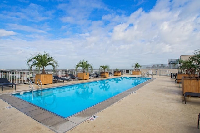 view of swimming pool with a patio