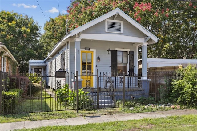 bungalow-style home with a porch and a front lawn