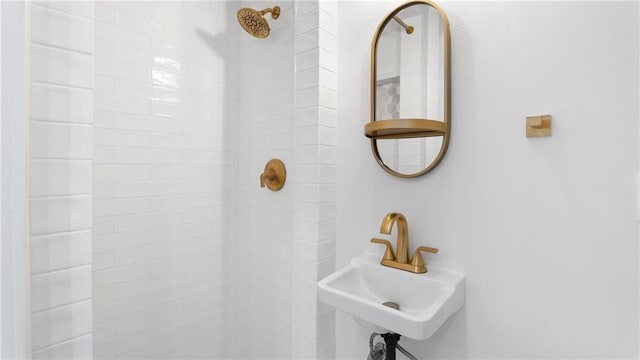 bathroom with sink and tiled shower